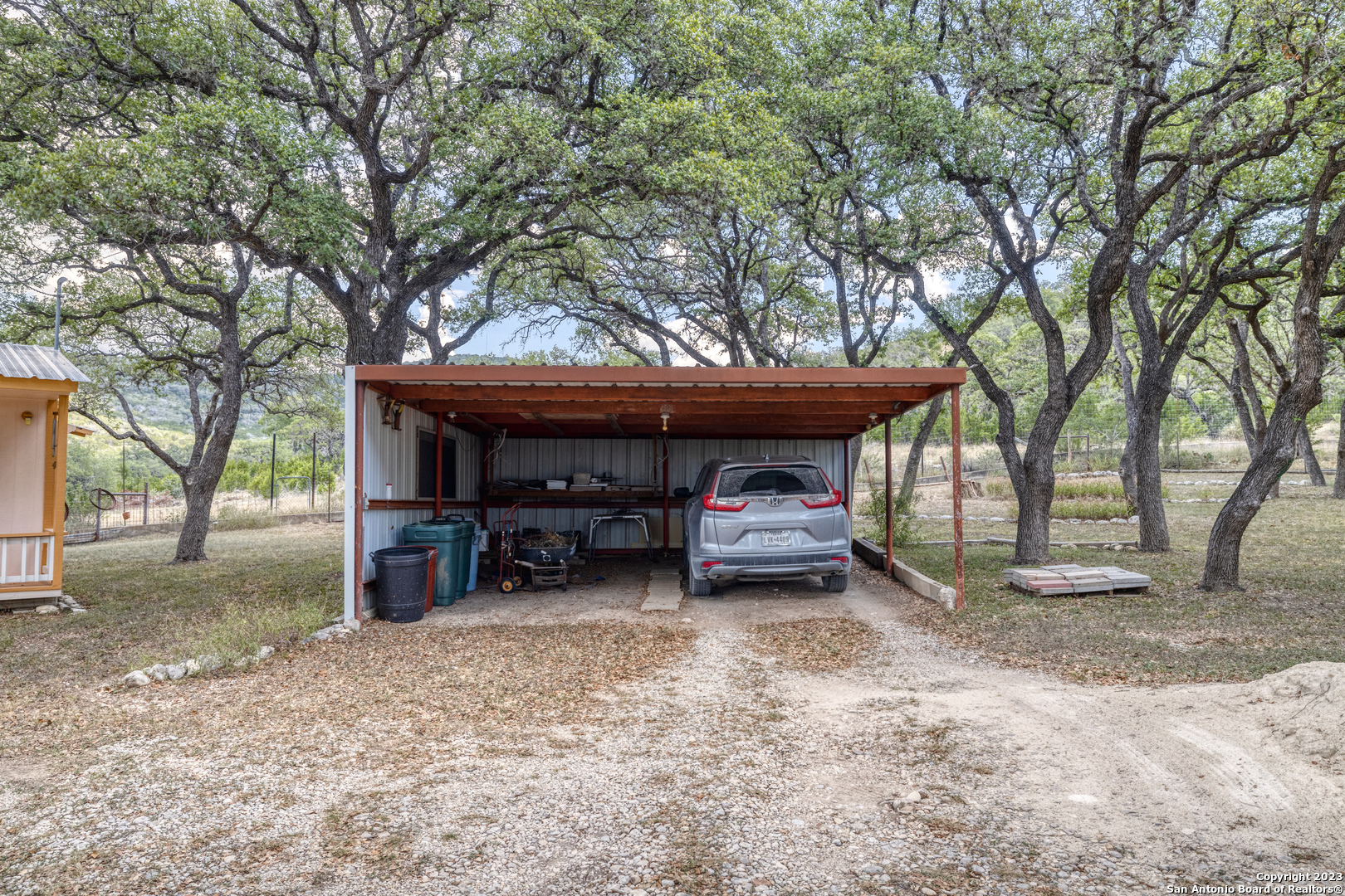 1482 Flatrock Circle Rio Frio, TX 78879 - Photo 21 of 34 a view of backyard with large trees and a barn