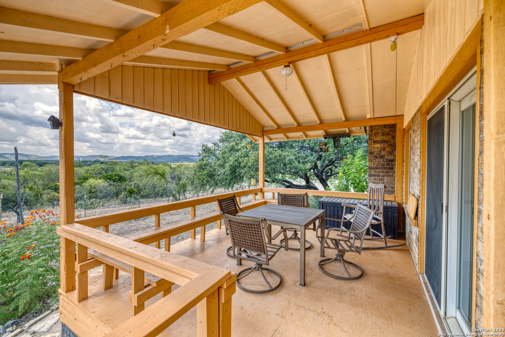 1482 Flatrock Circle Rio Frio, TX 78879 - Photo 26 of 34 a view of a patio with table and chairs under an umbrella
