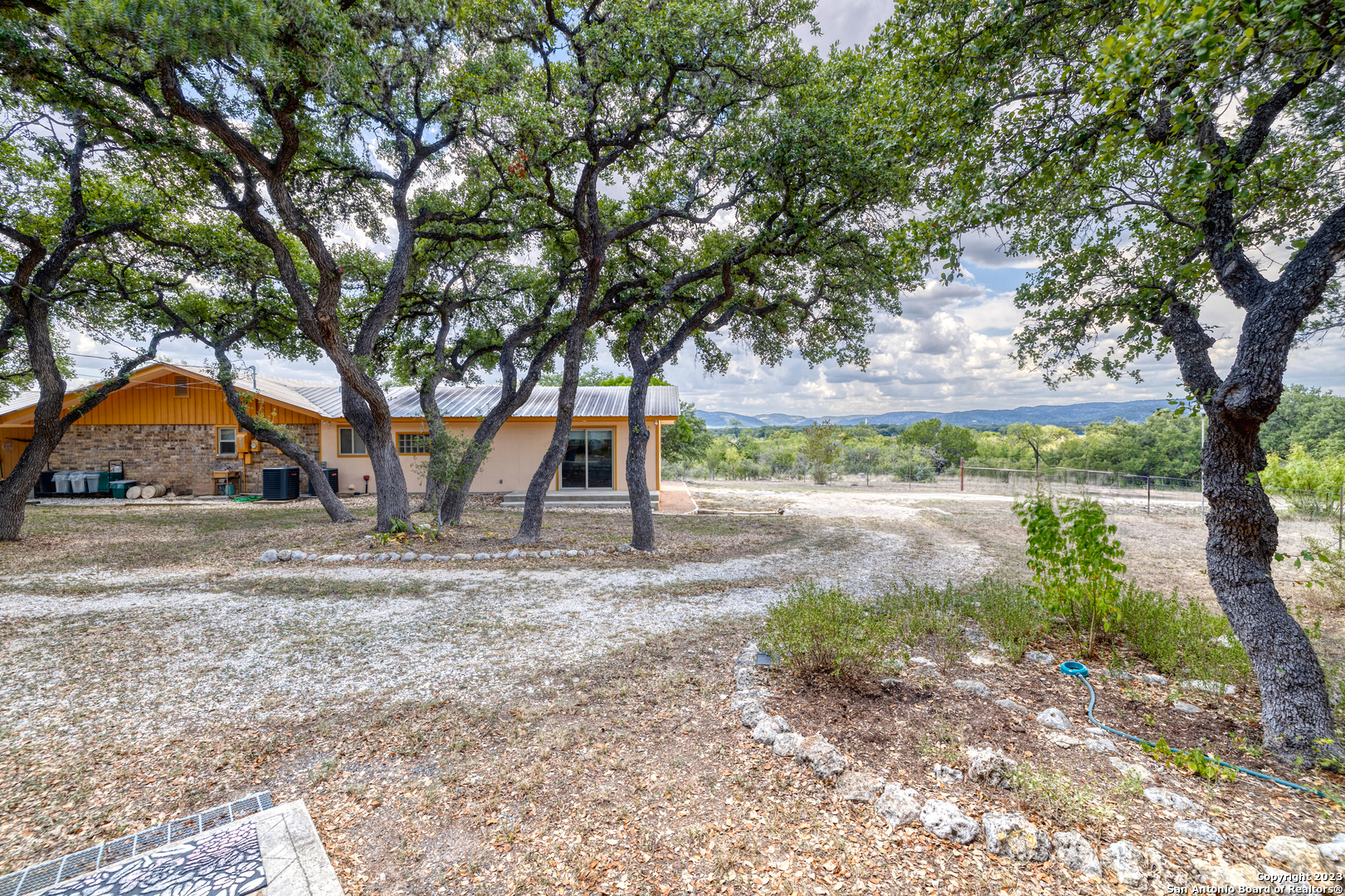1482 Flatrock Circle Rio Frio, TX 78879 - Photo 4 of 34 a view of a yard with plants and a tree