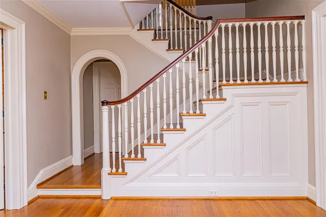 a picture of a room with a white wall and a large window