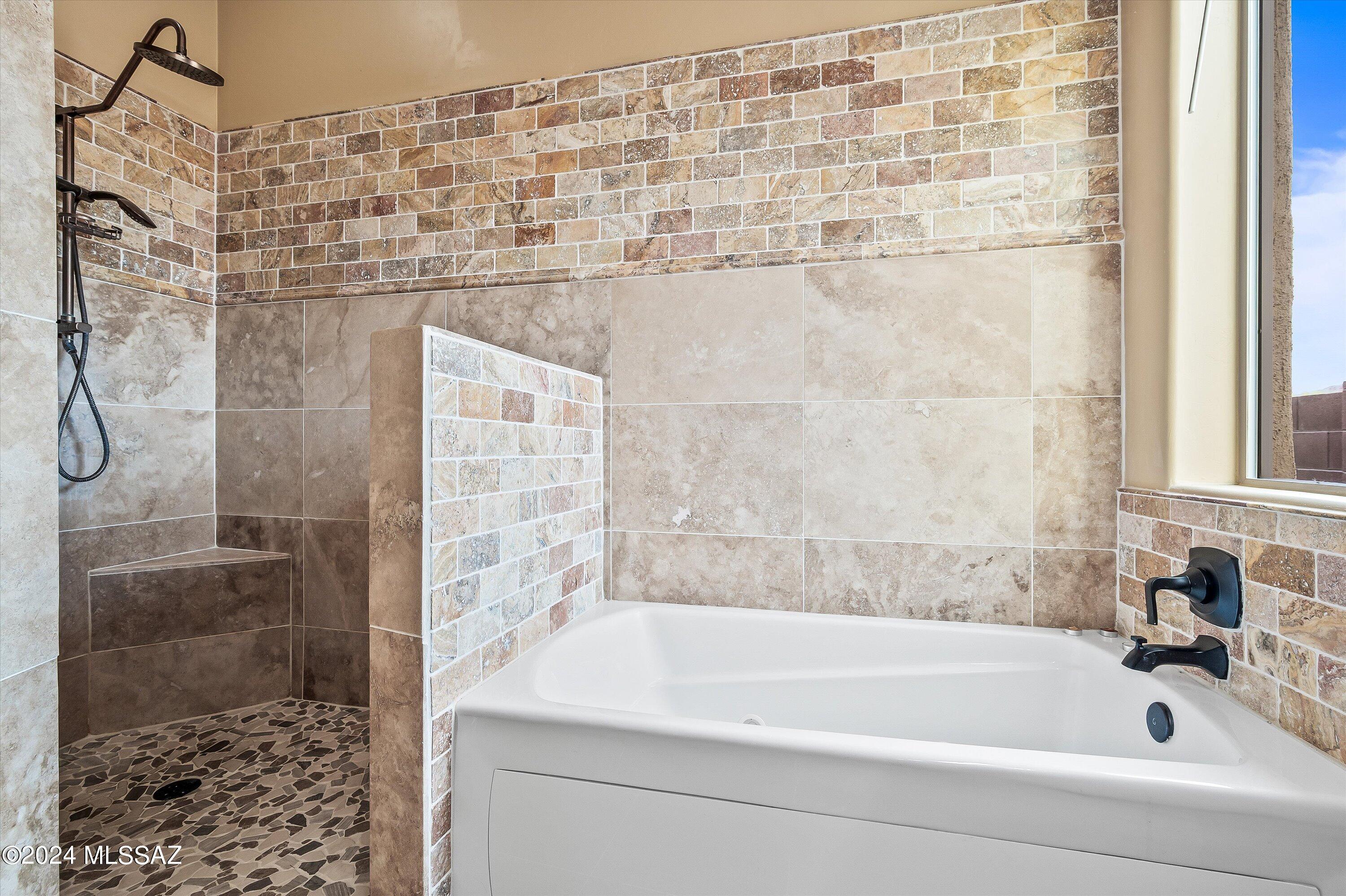 8579 North Shadow Wash Way Tucson, AZ 85743 - Photo 23 of 34 a bathroom with a bathtub and shower