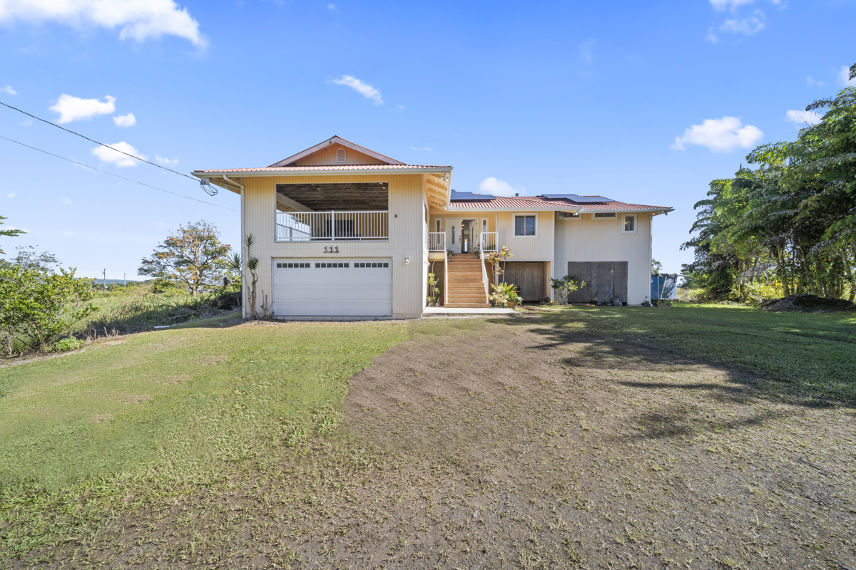 111 Alawaena Street Hilo, HI 96720 - Photo 1 of 28 a front view of a house with a yard and garage