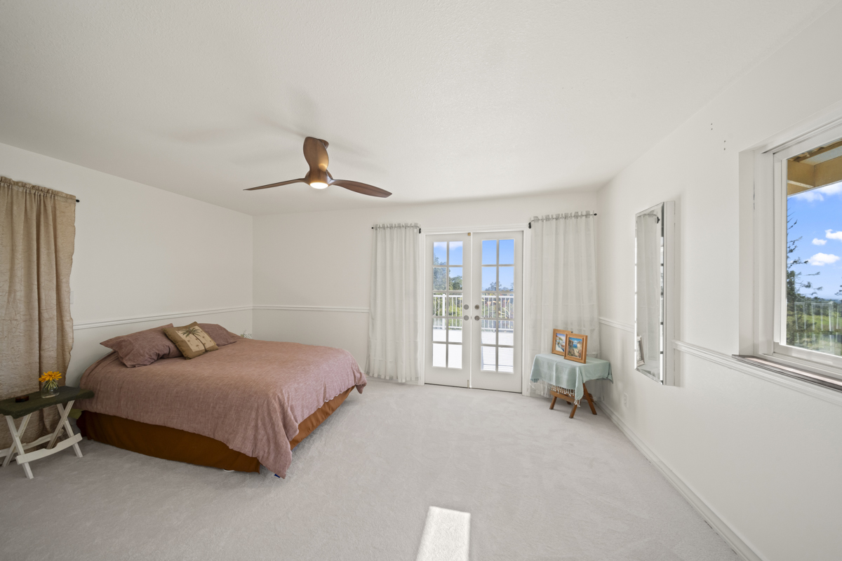 111 Alawaena Street Hilo, HI 96720 - Photo 11 of 28 a bedroom with a bed and a window