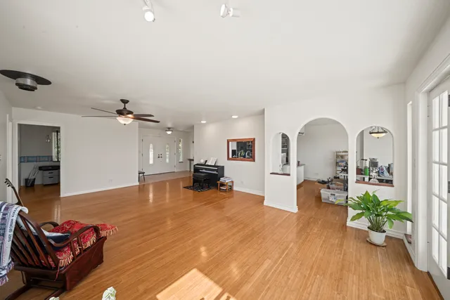 a living room with furniture and a wooden floor