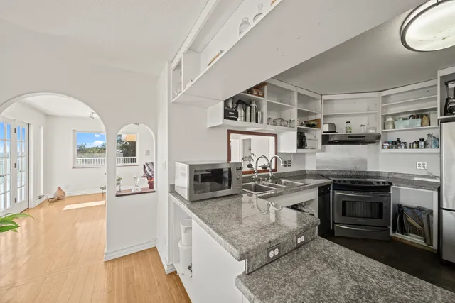 a kitchen with stainless steel appliances granite countertop a stove and a sink