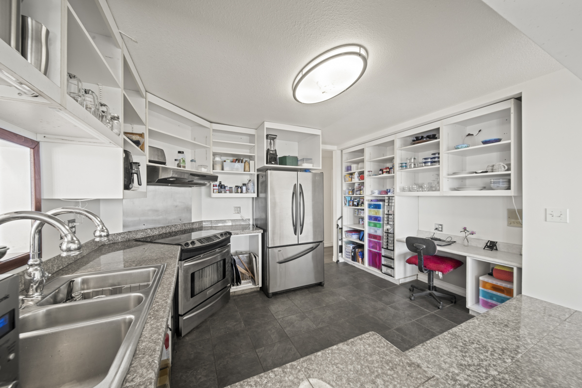 111 Alawaena Street Hilo, HI 96720 - Photo 9 of 28 a view of a kitchen with fridge and a sink