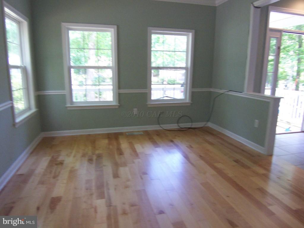 25 Sandyhook Road Ocean Pines, MD 21811 - Photo 3 of 8 an empty room with wooden floor and windows