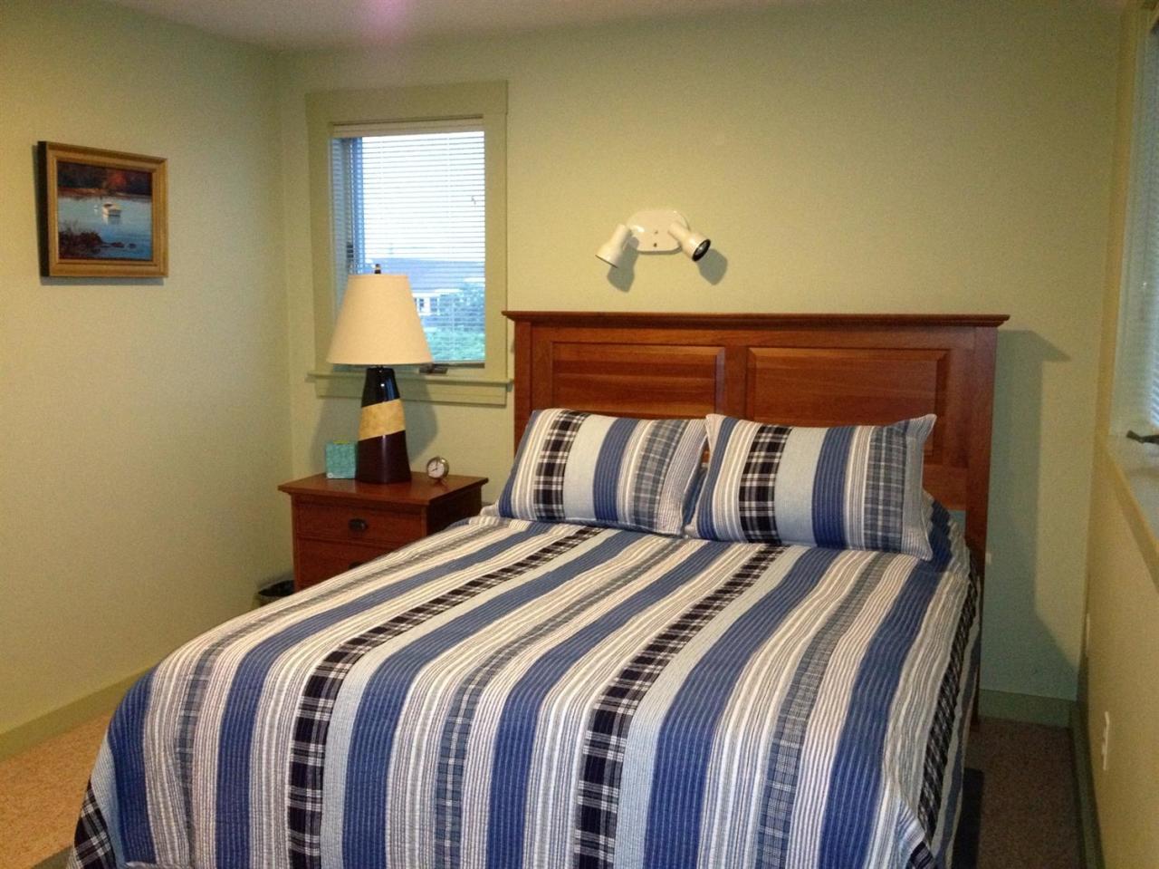 25 Bay View Road Truro, MA 02666 - Photo 17 of 21 a bedroom with a bed and a lamp with the wooden floor