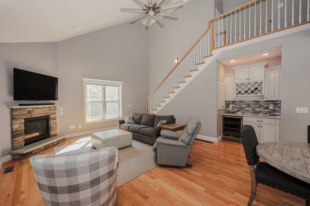 327 North Amherst Road Bedford, NH 03110 - Photo 17 of 39 a living room with furniture fireplace and flat screen tv