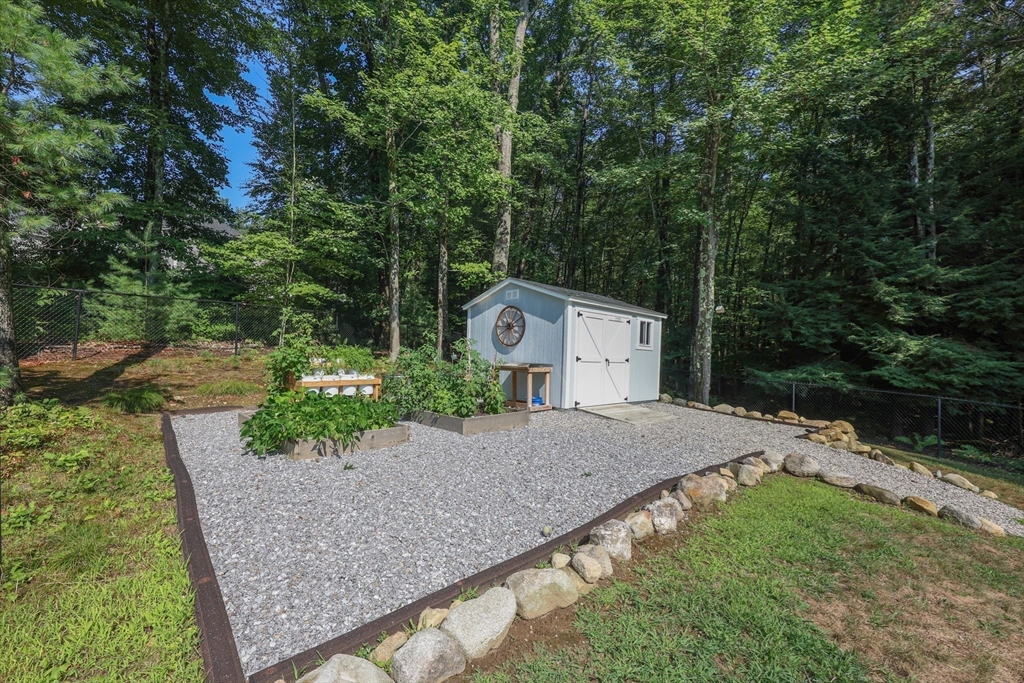 327 North Amherst Road Bedford, NH 03110 - Photo 35 of 39 a front view of a house with a yard and garage