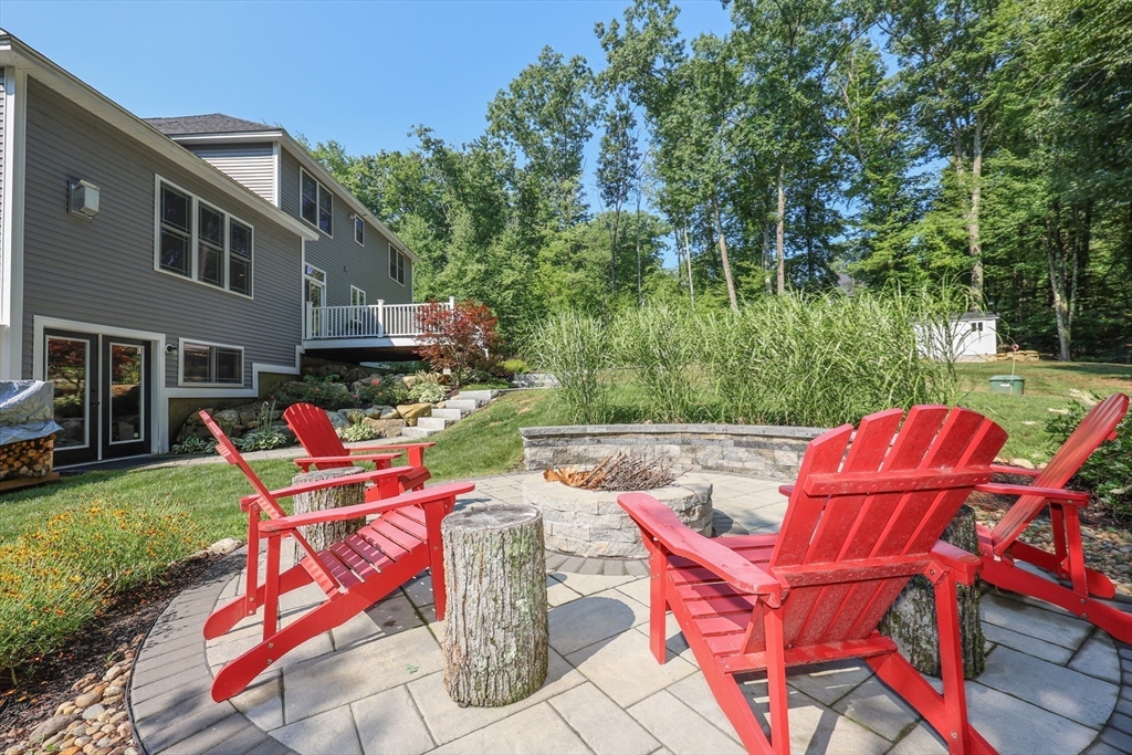 327 North Amherst Road Bedford, NH 03110 - Photo 36 of 39 a backyard of a house with table and chairs