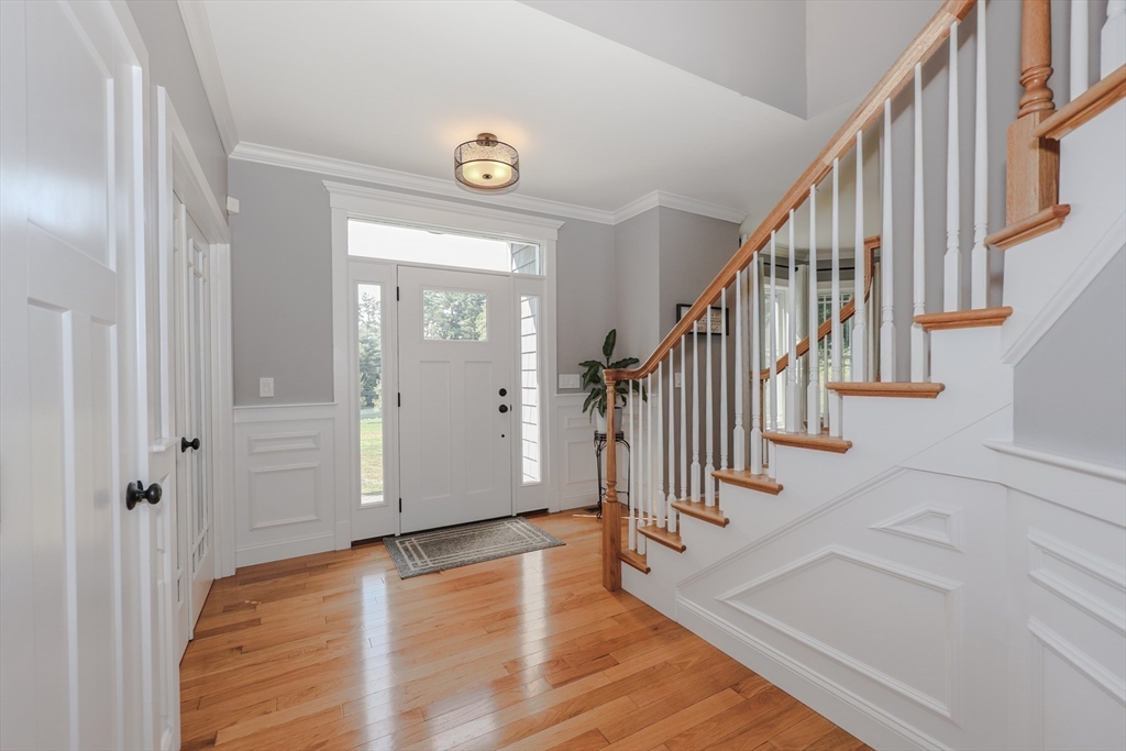327 North Amherst Road Bedford, NH 03110 - Photo 5 of 39 a view of entryway with wooden floor and stairs