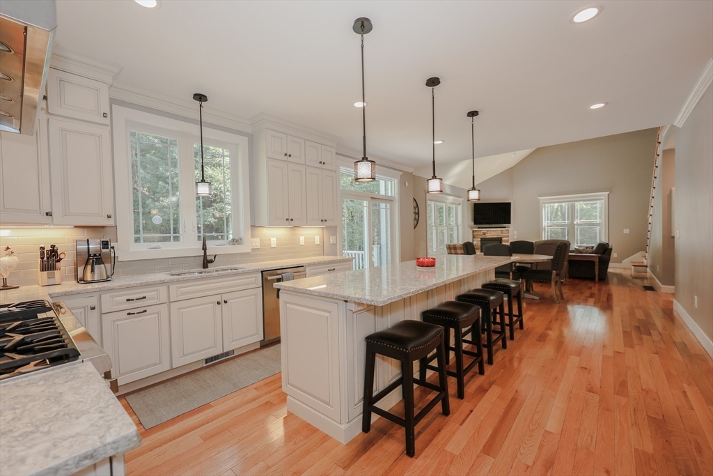 327 North Amherst Road Bedford, NH 03110 - Photo 6 of 39 a large kitchen with lots of counter space and windows