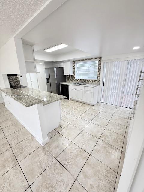 11570 Southwest 83rd Terrace Miami, FL 33173 - Photo 12 of 27 a kitchen with stainless steel appliances granite countertop a sink stove and cabinets