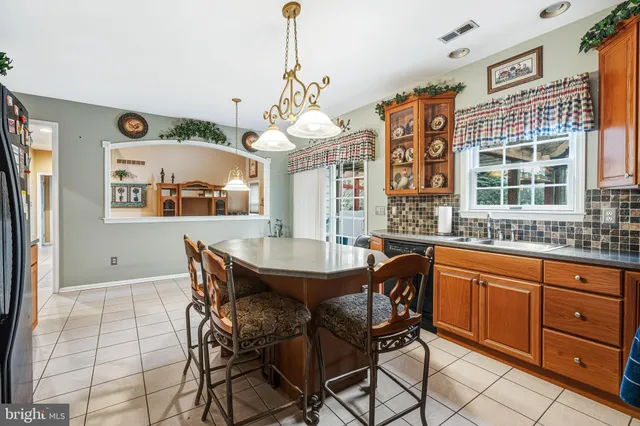 a dining room with a granite top table and chairs