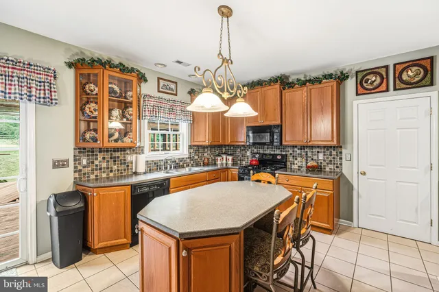 a kitchen with a table chairs and a refrigerator