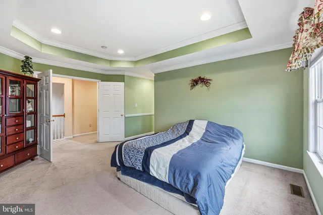 a spacious bedroom with a bed and a chandelier