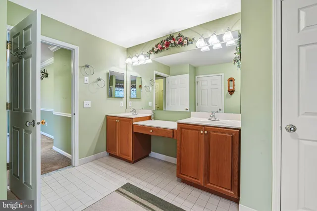 a bathroom with a sink vanity and a mirror