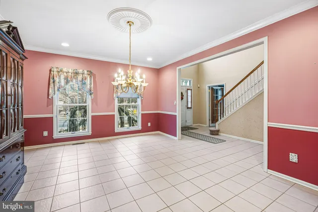 a view of entryway with a window and chandelier