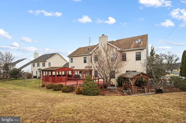 a view of a big house with a big yard and large trees