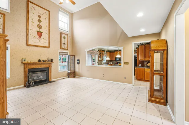 a view of a hallway with wooden floor and a fireplace