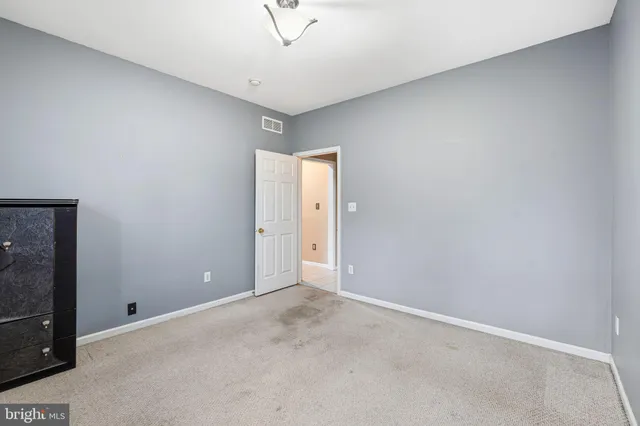 an empty room with a empty space and windows