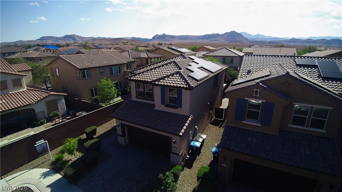 11045 Elk Sands Road Las Vegas, NV 89179 - Photo 66 of 67 Distant mountains frame a peaceful neighborhood of contemporary houses.