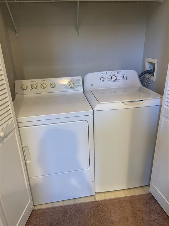 3403 Greenwich Village Boulevard, Unit 203 Orlando, FL 32835 - Photo 11 of 16 a utility room with dryer and washer