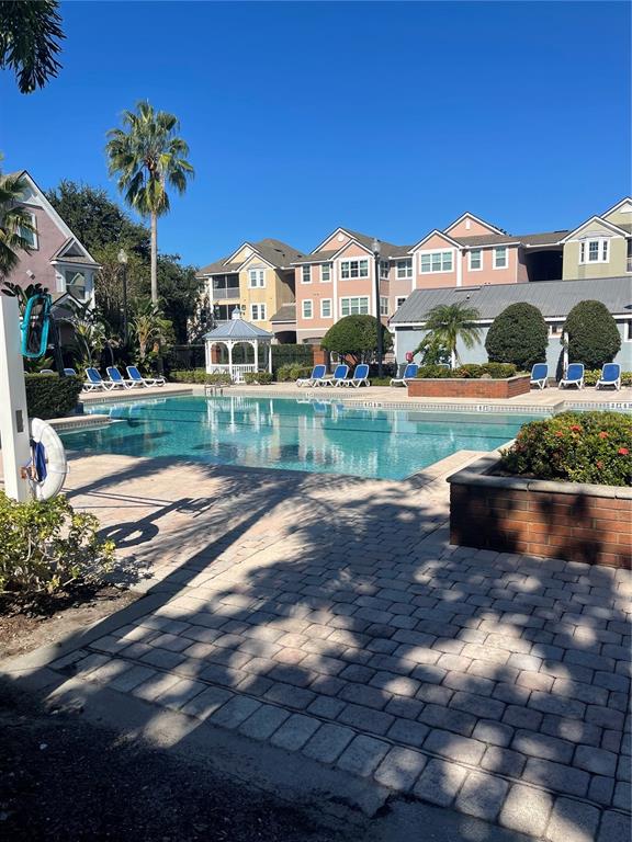 3403 Greenwich Village Boulevard, Unit 203 Orlando, FL 32835 - Photo 13 of 16 a front view of a house with a yard