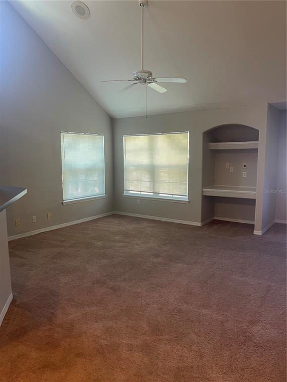 3403 Greenwich Village Boulevard, Unit 203 Orlando, FL 32835 - Photo 4 of 16 an empty room with a empty space and windows