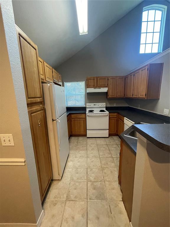 3403 Greenwich Village Boulevard, Unit 203 Orlando, FL 32835 - Photo 6 of 16 a kitchen with stainless steel appliances a refrigerator and a stove