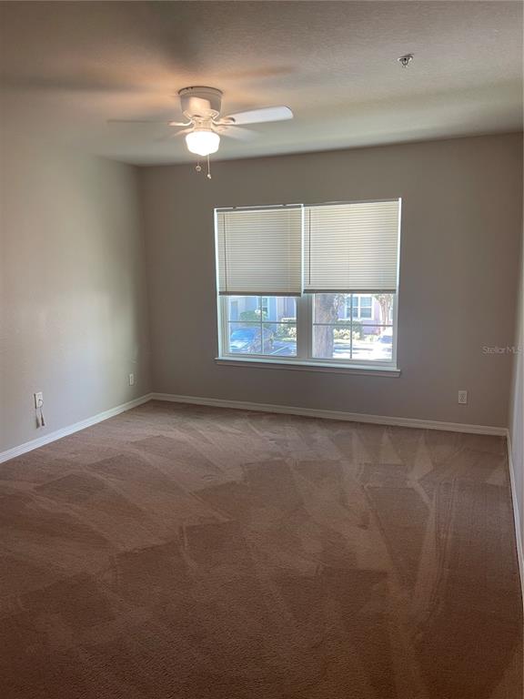 3403 Greenwich Village Boulevard, Unit 203 Orlando, FL 32835 - Photo 7 of 16 a view of an empty room with a window