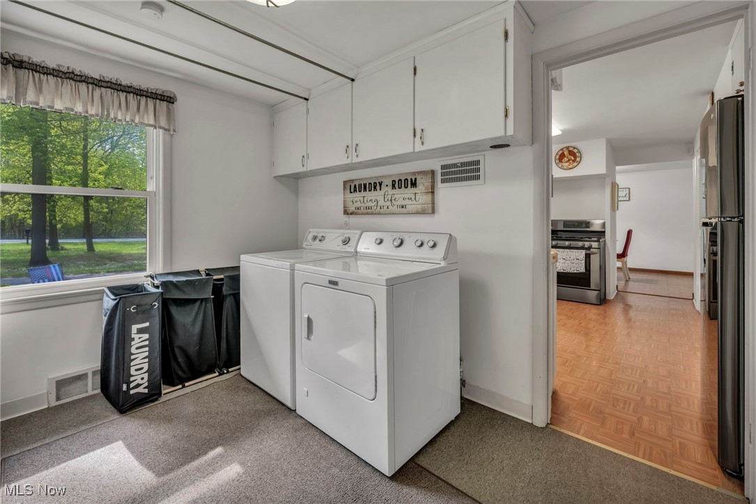 8665 Johnnycake Ridge Road Mentor, OH 44060 - Photo 26 of 49 Washroom with separate washer and dryer, cabinet space, and baseboards