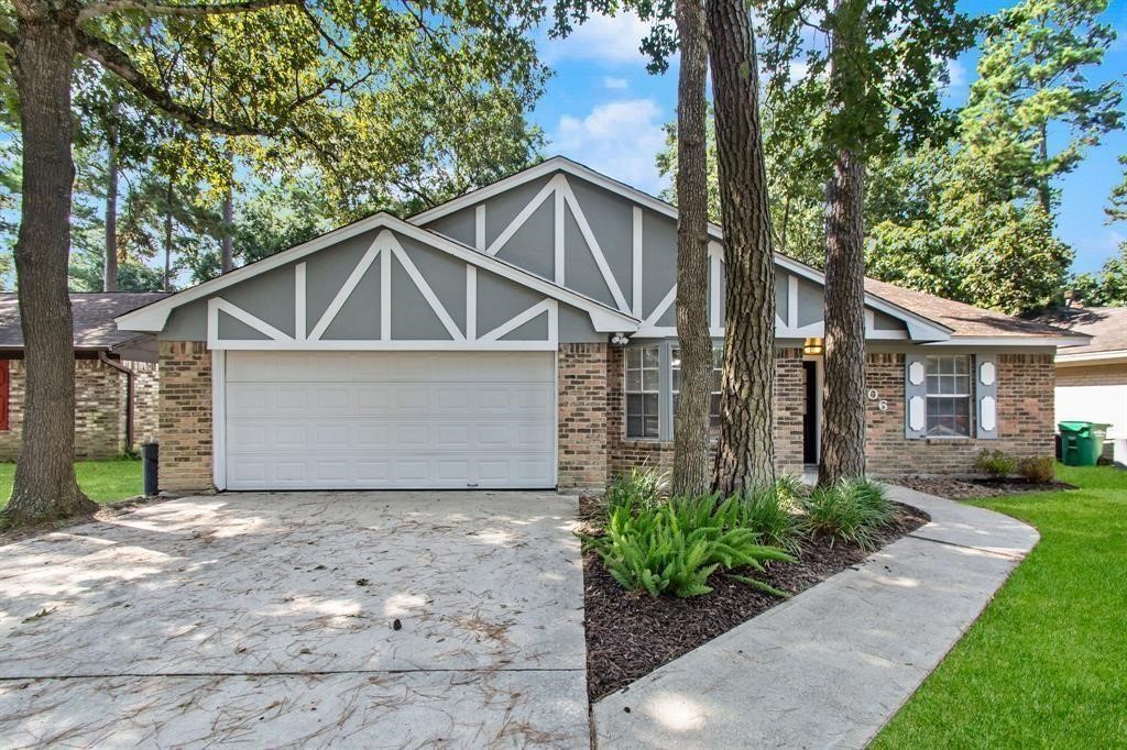 2106 Wickburn Drive Spring, TX 77386 - Photo 2 of 18 a front view of a house with a yard and garage