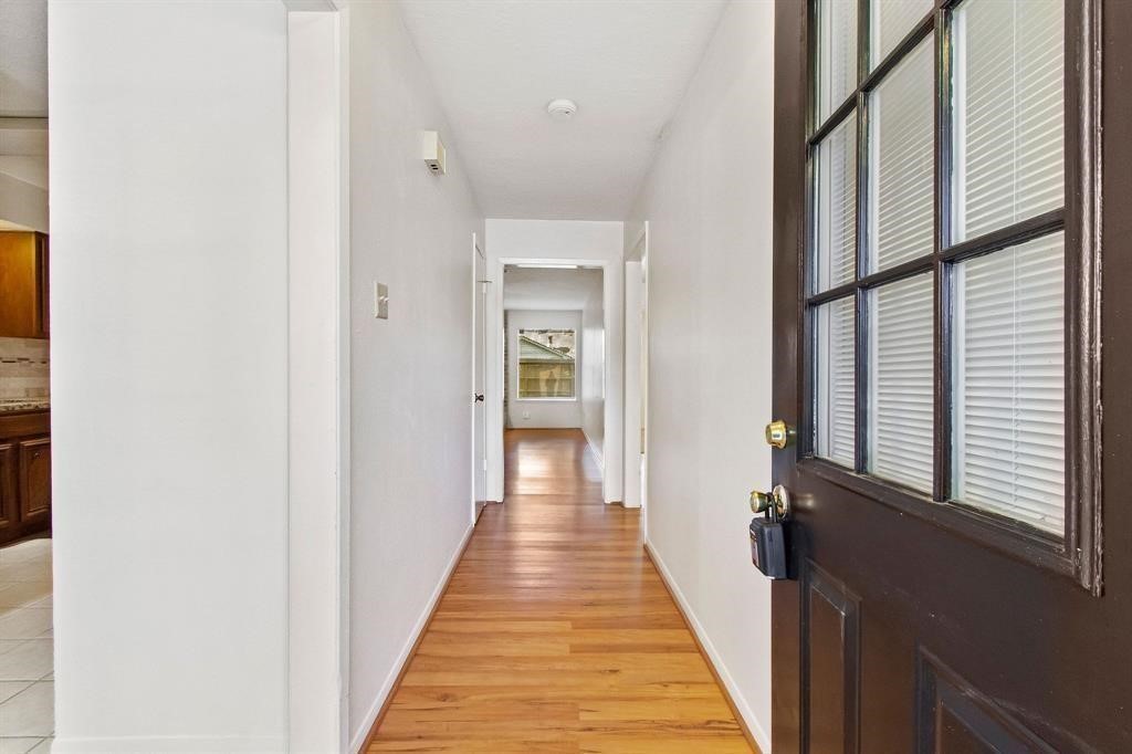 2106 Wickburn Drive Spring, TX 77386 - Photo 4 of 18 a view of a hallway with wooden floor and staircase