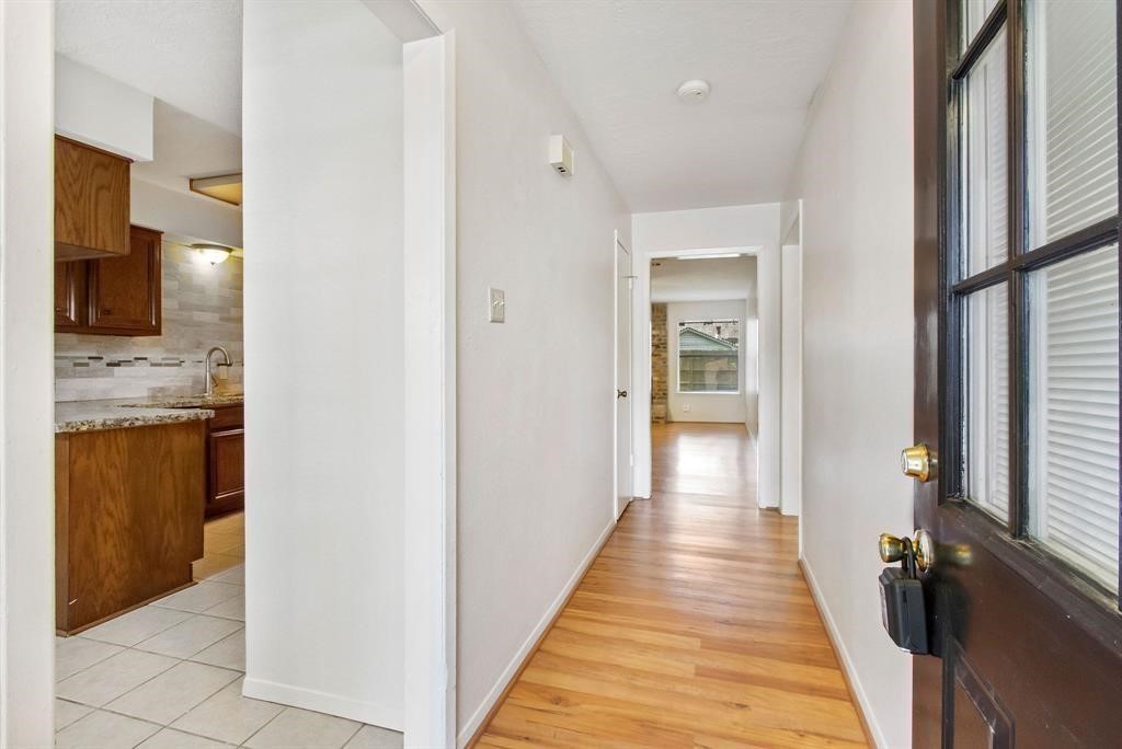2106 Wickburn Drive Spring, TX 77386 - Photo 6 of 18 a view of a hallway with wooden floor and a living room