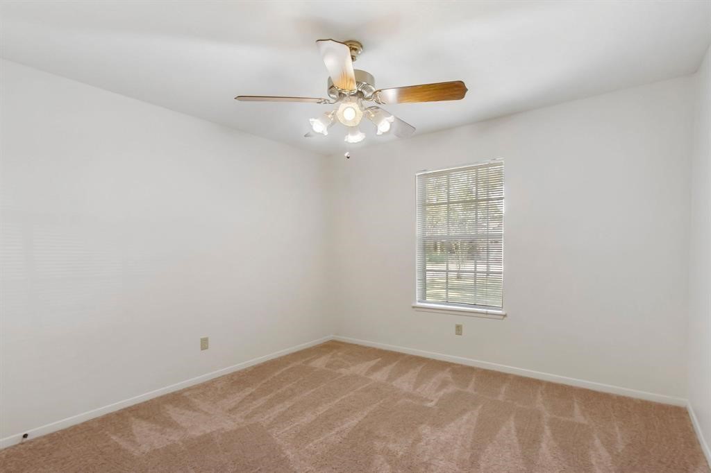 2106 Wickburn Drive Spring, TX 77386 - Photo 8 of 18 an empty room with window and fan