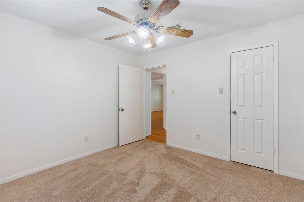 2106 Wickburn Drive Spring, TX 77386 - Photo 9 of 18 an empty room with fan and a chandelier fan