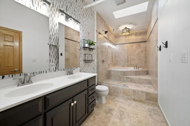 a bath tub sitting next to a white sink and a shower