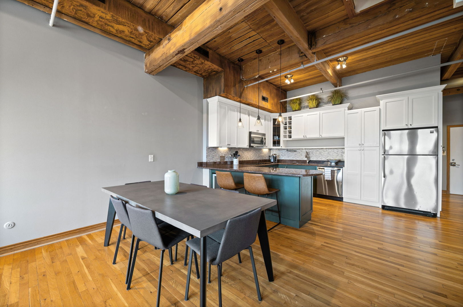 1101 West Armitage Avenue, Unit 204 Chicago, IL 60614 - Photo 4 of 17 a kitchen with a table chairs and wooden floor