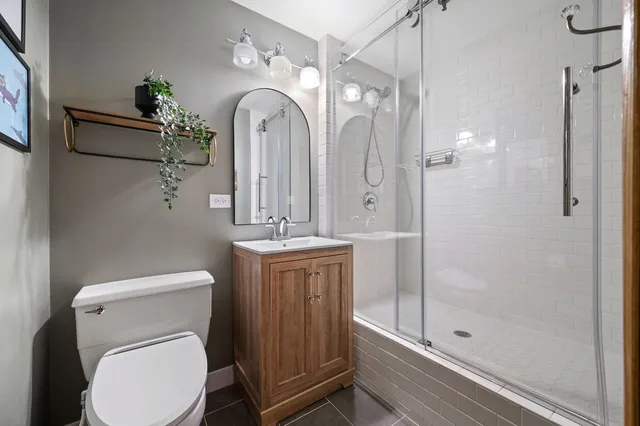 a bathroom with a toilet a sink and shower