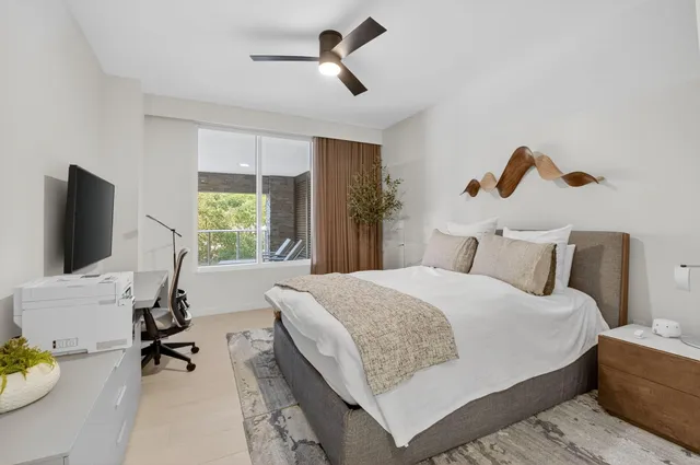 a bedroom with a bed and a flat screen tv