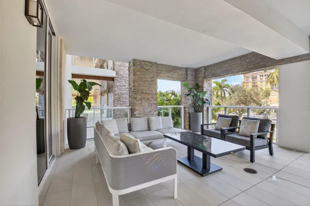 a living room with furniture and a floor to ceiling window