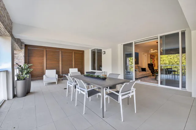 a dinning area with furniture and a potted plant