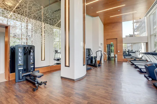 a view of a livingroom with furniture and a floor to ceiling window