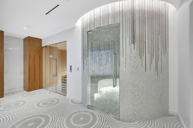 a bedroom with a bed and a glass door