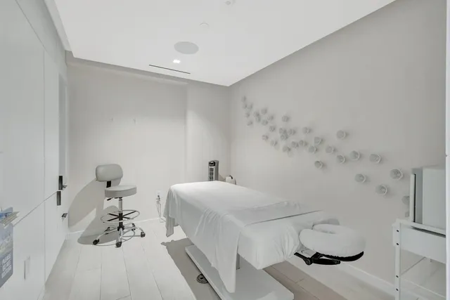 a bedroom with a bed and white walls