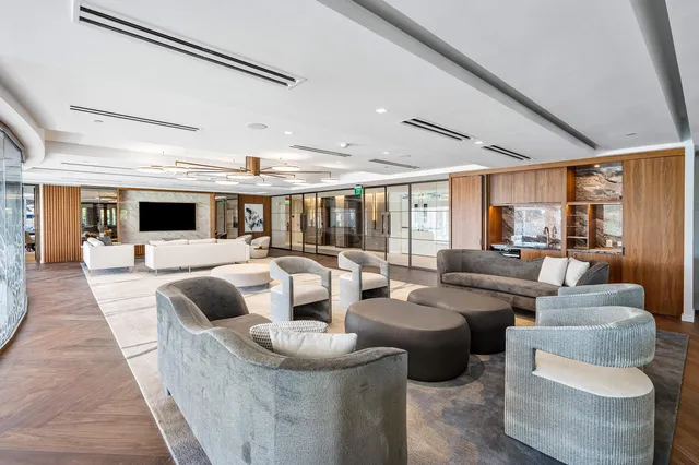 a living room with fireplace furniture and a large window