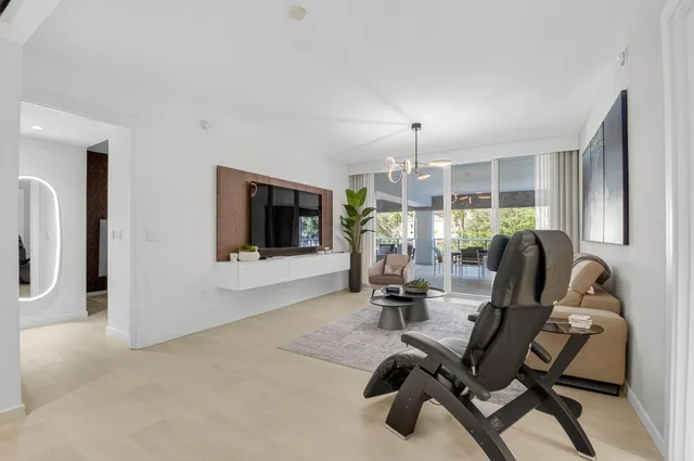 a view of a livingroom with furniture and a flat screen tv