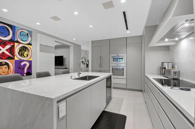 a kitchen with stainless steel appliances granite countertop a sink and a refrigerator